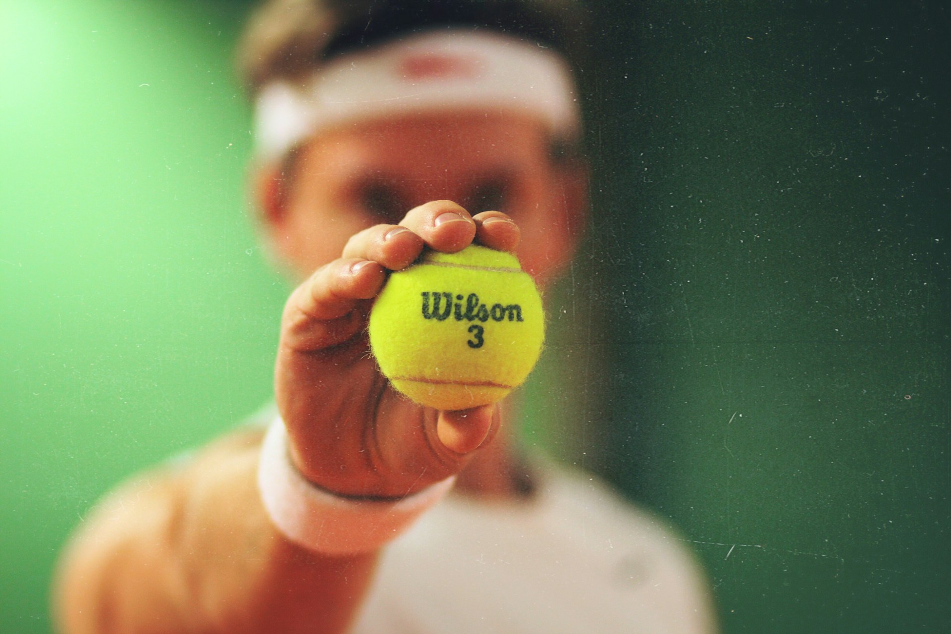 a tennis coach holding a tennis ball